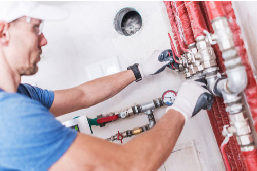 Technician checking condo plumbing in Davie, Florida