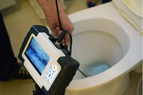 Plumbing video inspections in Davie Florida plumber checks toilet clog with camera