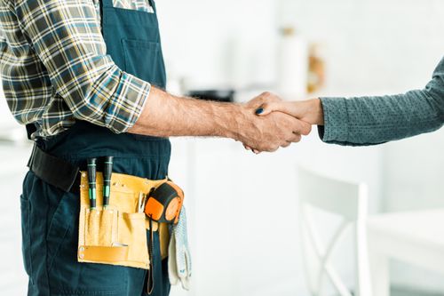 Image is of a plumber and customer shaking hands, concept of Boca Raton residential plumbing